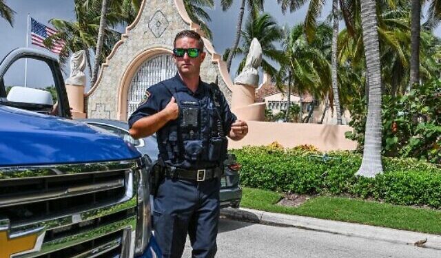 Local law enforcement officers are seen in front of the home of former President Donald Trump at Mar-A-Lago in Palm Beach, Florida on August 9, 2022. - Former US president Donald Trump said August 8, 2022 that his Mar-A-Lago residence in Florida was being "raided" by FBI agents in what he called an act of "prosecutorial misconduct." (Photo by Giorgio Viera / AFP)