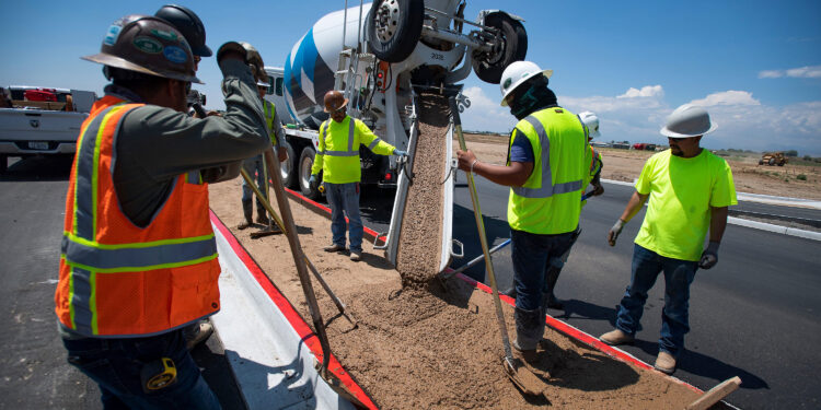 Construction workers pour concrete into a median along Larimer County Road 5 near Windsor, Colo. on Friday, July 2, 2021.

070221 Construction 04 Bb