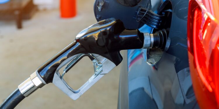 Gas station pump car fill with gasoline at a gas station.